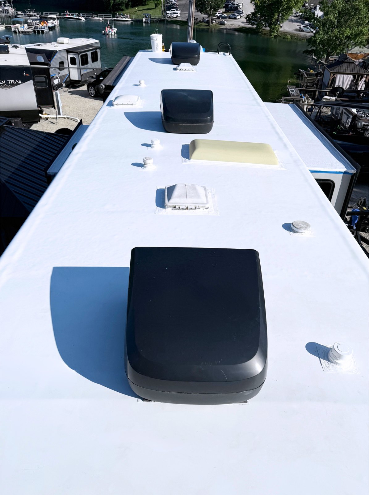 The same lakeside RV roof after a bright white seamless coating